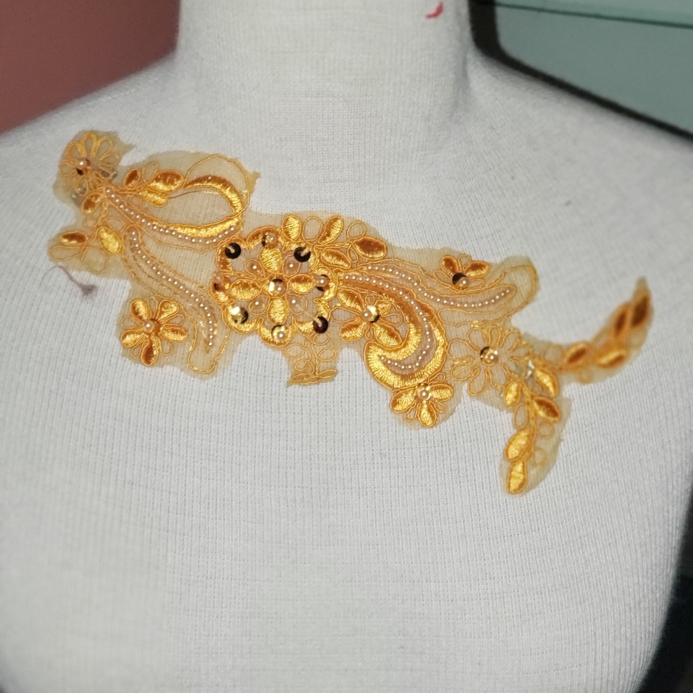 A gold beaded pin